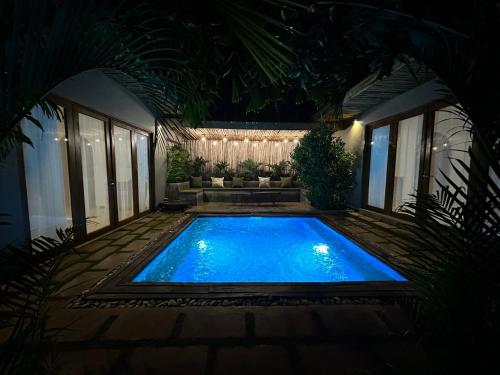 a swimming pool in the middle of a yard at night at Tulivu Kilimanjaro Retreat in Moshi