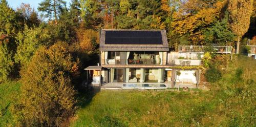 a house with a solar panel on top of it at Thomizil Eichberg Südsteiermark in Sankt Johann im Saggautal