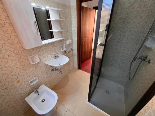 a bathroom with a sink and a shower at Residence Casa Pineta in Principina a Mare