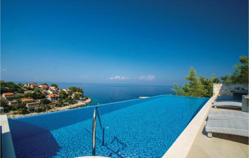 a swimming pool with a view of the ocean at Pet Friendly Home In Prigradica in Prigradica