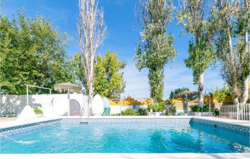 a swimming pool in a yard with trees at 6 Bedroom Amazing Home In Lucena in Lucena