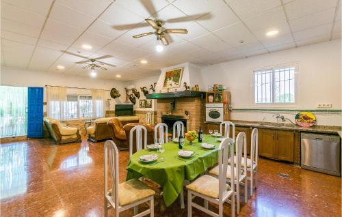 a kitchen and living room with a table and chairs at 6 Bedroom Amazing Home In Lucena in Lucena