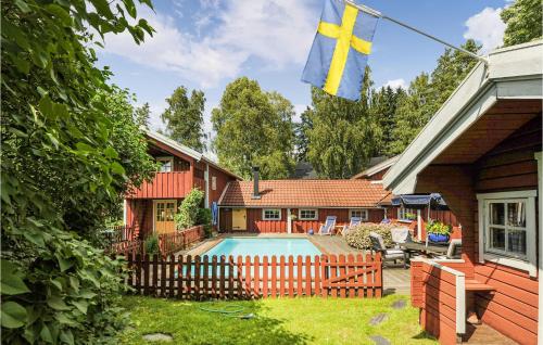 a house with a swimming pool and a flag at 3 Bedroom Cozy Home In Hillared in Hillared