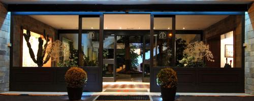 a front door of a store with potted plants in front at Pràti Home in Rome