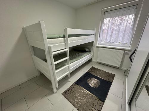 a white bunk bed in a room with a window at Stilvolles Apartment im modernen Ambiente in Tuttlingen in Tuttlingen