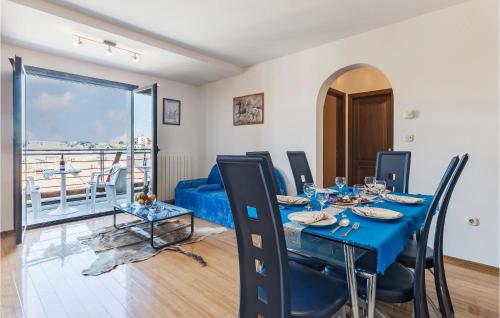 a dining room with a table and chairs and a balcony at 1 Bedroom Beautiful Apartment In Pula in Pula