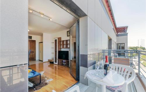 a room with a balcony with a table and a tv at 1 Bedroom Beautiful Apartment In Pula in Pula
