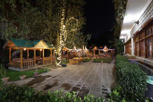 a garden with a group of gazebos with lights at Hide-in Old Manali in Manāli