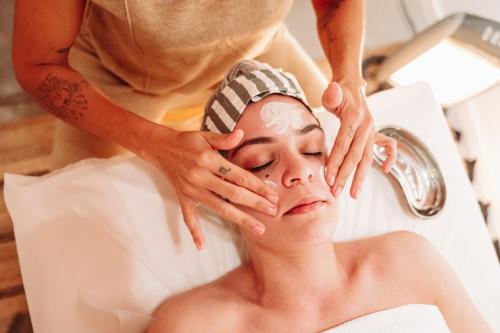a woman getting her face rejuvenated by a cosmetic therapist at Tomarhousing - Style in Tomar