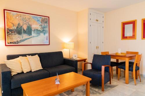 a living room with a couch and a table at Ramada Hotel & Suites by Wyndham Costa del Sol in Fuengirola