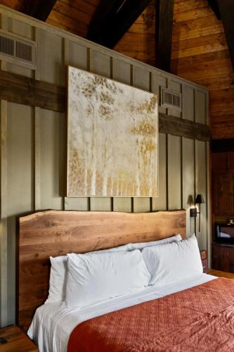 a bedroom with a bed with a painting on the wall at Ancient Lore Village in Knoxville