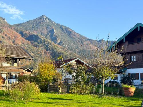 a group of houses in front of a mountain at Achentaler Alpentor in Marquartstein