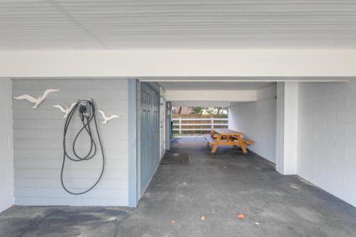 a hose hanging on the wall of a house at Steps to Ocean Colorful Abode in Fenwick Island in Fenwick Island