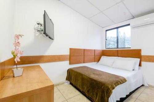 Ein Bett oder Betten in einem Zimmer der Unterkunft Pousada Queiroz