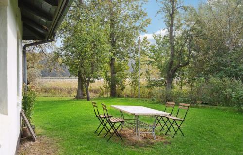 a table and chairs sitting in the grass at Gorgeous Home In Næstved in Næstved