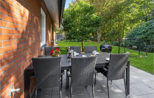 a dining table and chairs on a patio at Beautiful Home In Varde With Kitchen in Varde