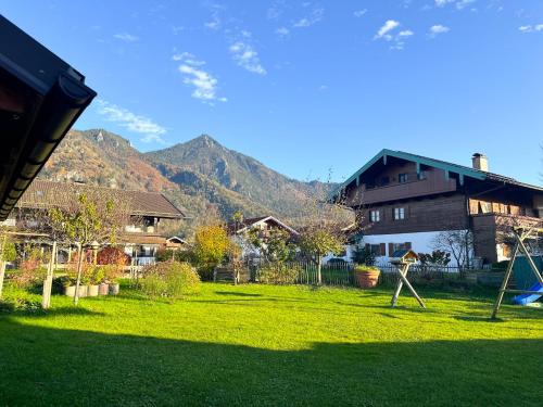 a person playing in a yard with a playground at Achentaler Alpentor in Marquartstein