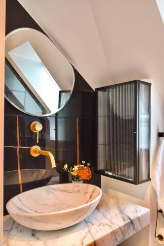 a bathroom with a large marble sink and a mirror at Central Penthouse with Private Rooftop Terrace in Copenhagen