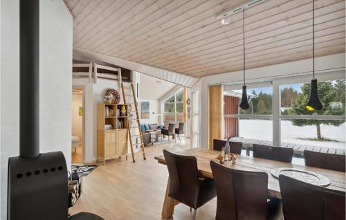 a dining room and living room with a table and chairs at Holiday Home Kuskevej Jerup Iv in Jerup