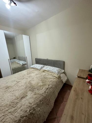 a bedroom with a large bed and a mirror at La casa del Sole in Castel di Sangro