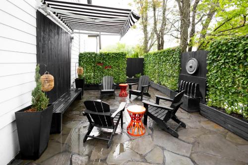 ベントンビルにあるPrivate Pet-friendly Secret Garden Loft Oasisのパティオ(黒い椅子、パラソル付きテーブル付)