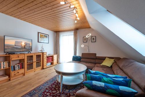 a living room with a couch and a table at Ackerweg, App 01 in Ueckeritz
