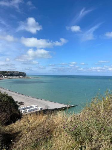 a view of a beach with boats in the water at La Perle in Mers-les-Bains