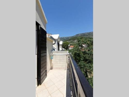 a balcony with a view of a house at Apartments Matej in Bol