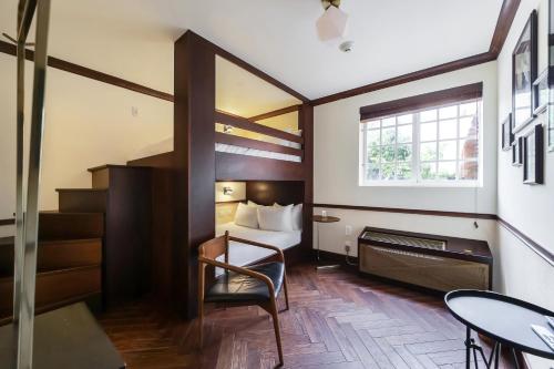 a hotel room with a bed and a table and chair at Jefferson Hotel in Miami