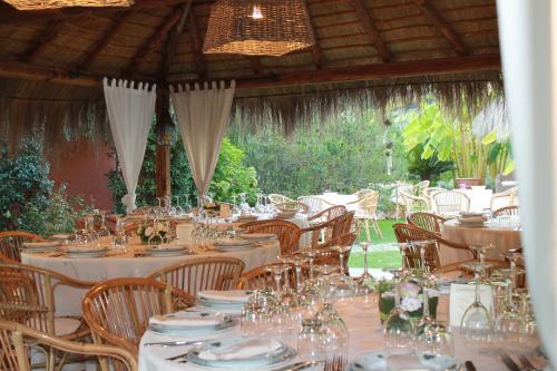 a table set up for a party with white tables and chairs at Antica Pietrara B&B in Formello