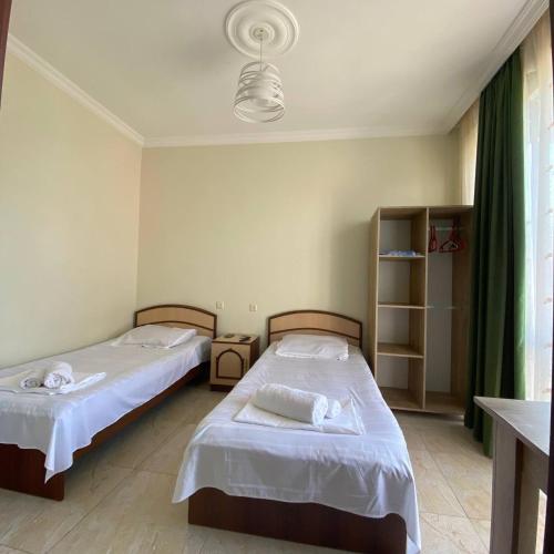 a bedroom with two beds and a window at Guest House Deme in K'obulet'i