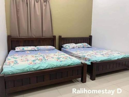 two beds sitting next to each other in a room at RALI PD HOME D 16Pax karaoke and swimming pool in Port Dickson