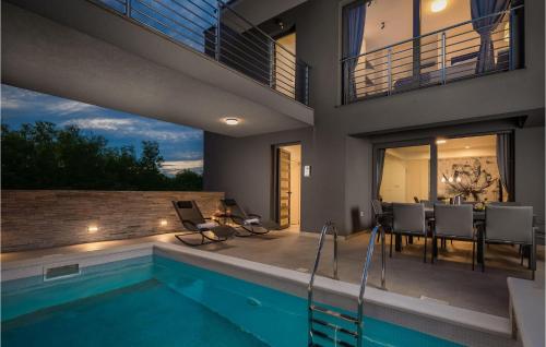 a house with a swimming pool and a patio at Villa Tina in Privlaka