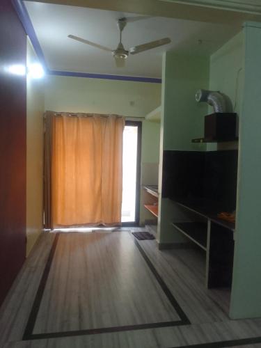 a living room with a window and a wooden floor at 2Bhk mayapur in mayapur
