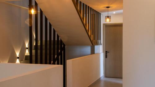 a staircase in a house with a hallway at Atoll Retreat in Fulidhoo