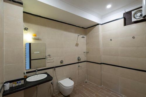 a bathroom with a toilet and a sink and a mirror at Hide-In Udaipur - A Lake View Boutique Hotel in Udaipur