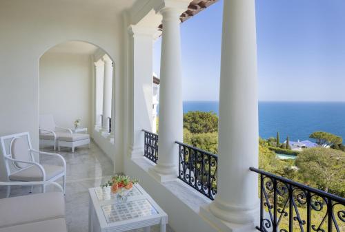 a white balcony with a view of the ocean at Grand-Hôtel du Cap-Ferrat, A Four Seasons Hotel in Saint-Jean-Cap-Ferrat
