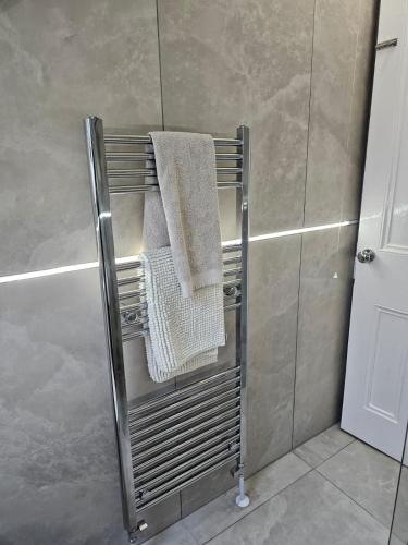a towel rack with two towels on it in a bathroom at Welcome to St Helena Dunoon, a traditional villa in Dunoon