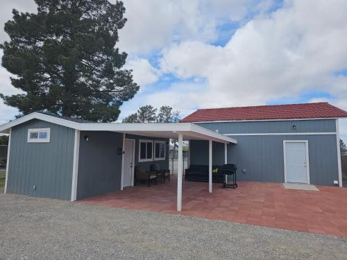 a gray garage with a roof and a patio at Sun Cabin #3 Pahrump in Pahrump