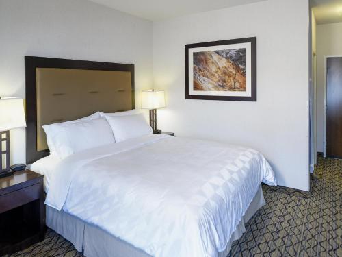 a large white bed in a hotel room at Holiday Inn West Yellowstone by IHG in West Yellowstone