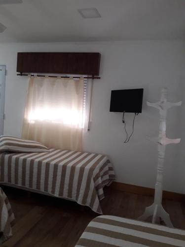 a bedroom with a bed and a tv in a room at Residencia del Norte in Federación