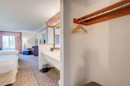 a bathroom with a sink and a bed in a room at Holiday Inn West Yellowstone by IHG in West Yellowstone