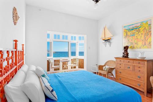 a bedroom with a bed and a table and chairs at Traditional Canary beach house in Poris de Abona