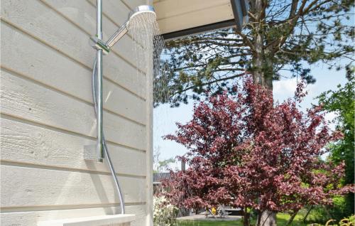 a water hose hooked up to a house with a tree at Gorgeous Home In Stege With Wifi in Stege