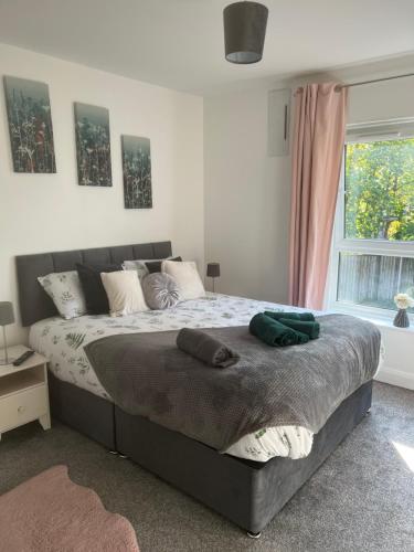 a bedroom with a large bed and a window at Flat in Greater Manchester in Manchester