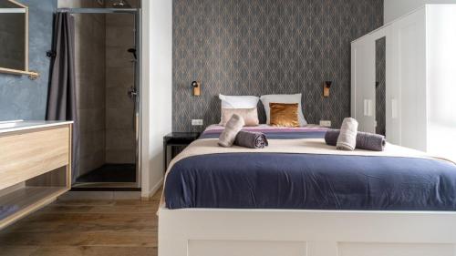 a bedroom with a large bed and a shower at Suite & Lake - Proche du Lac d'Annecy in Annecy