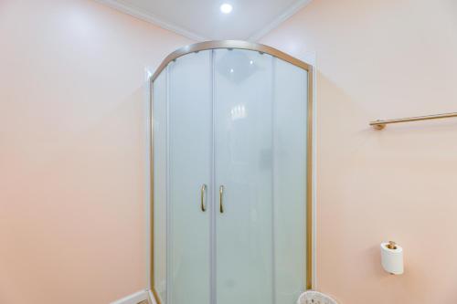 a shower with a glass door in a bathroom at Steps to Ocean Colorful Abode in Fenwick Island in Fenwick Island