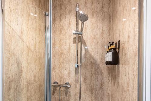a shower in a bathroom with a glass door at Quirky Studio in Central Reading in Reading
