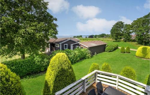 a house with a white fence in a yard at Holiday Home Teglbakken Iv in Egernsund