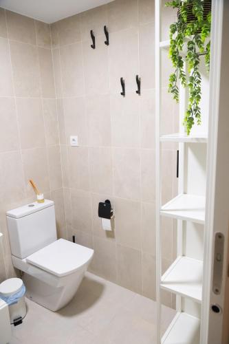 a bathroom with a white toilet in a room at El Toro Apartments in Altea